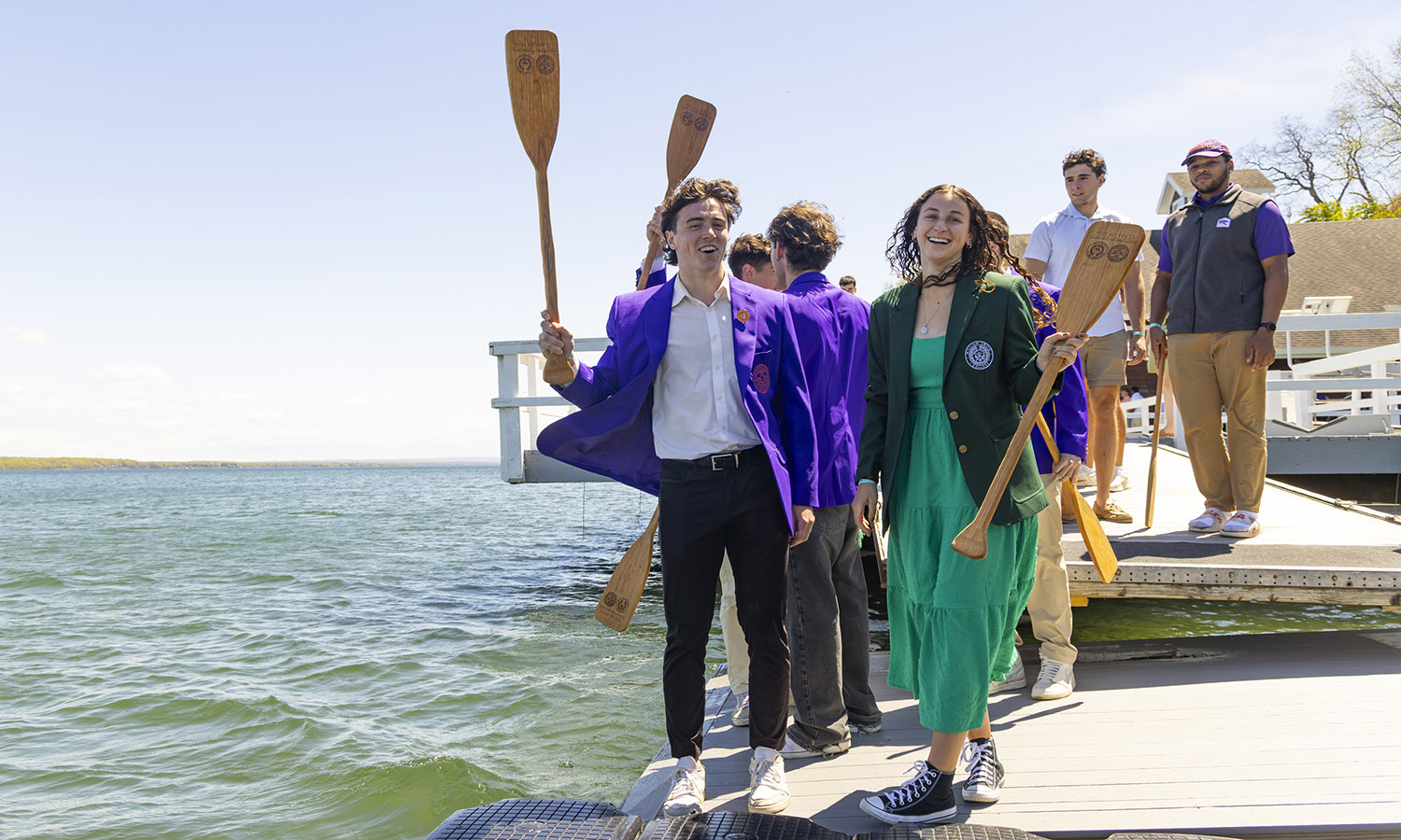 2 students by lake with paddles