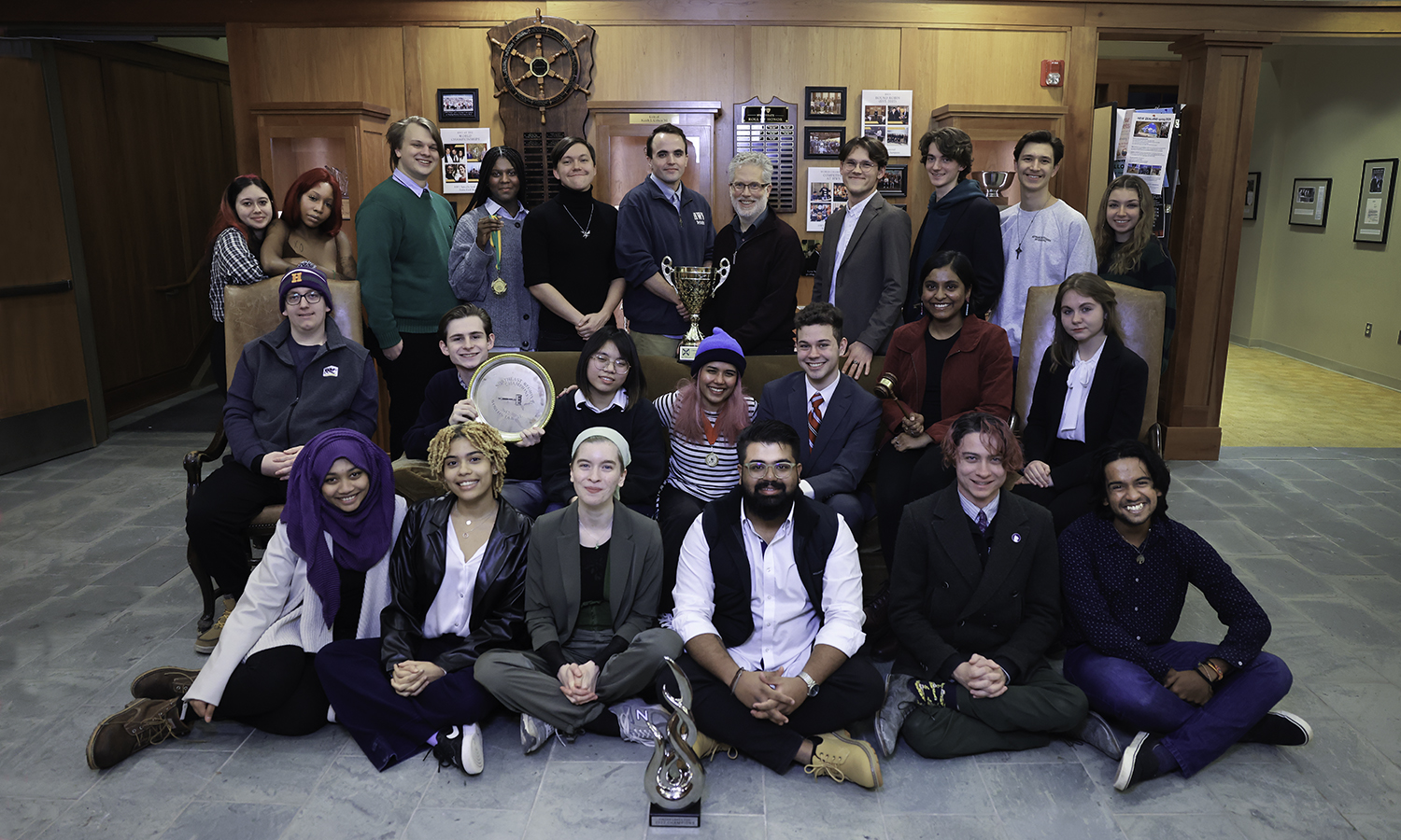 debate group photo holding trophies