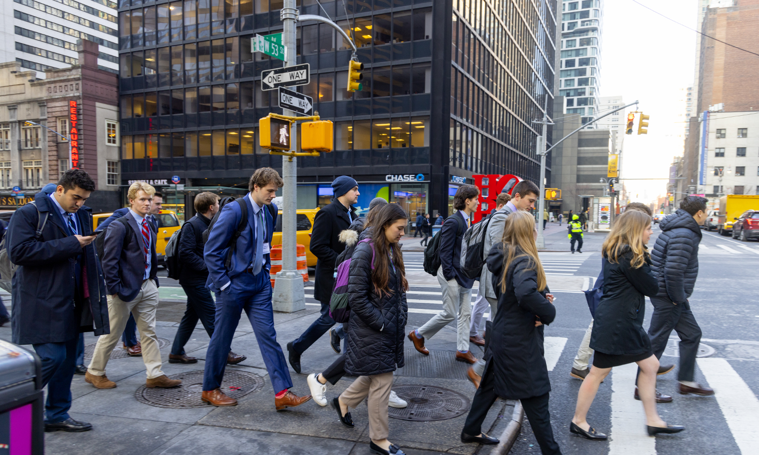 Students walk across a crosswalk