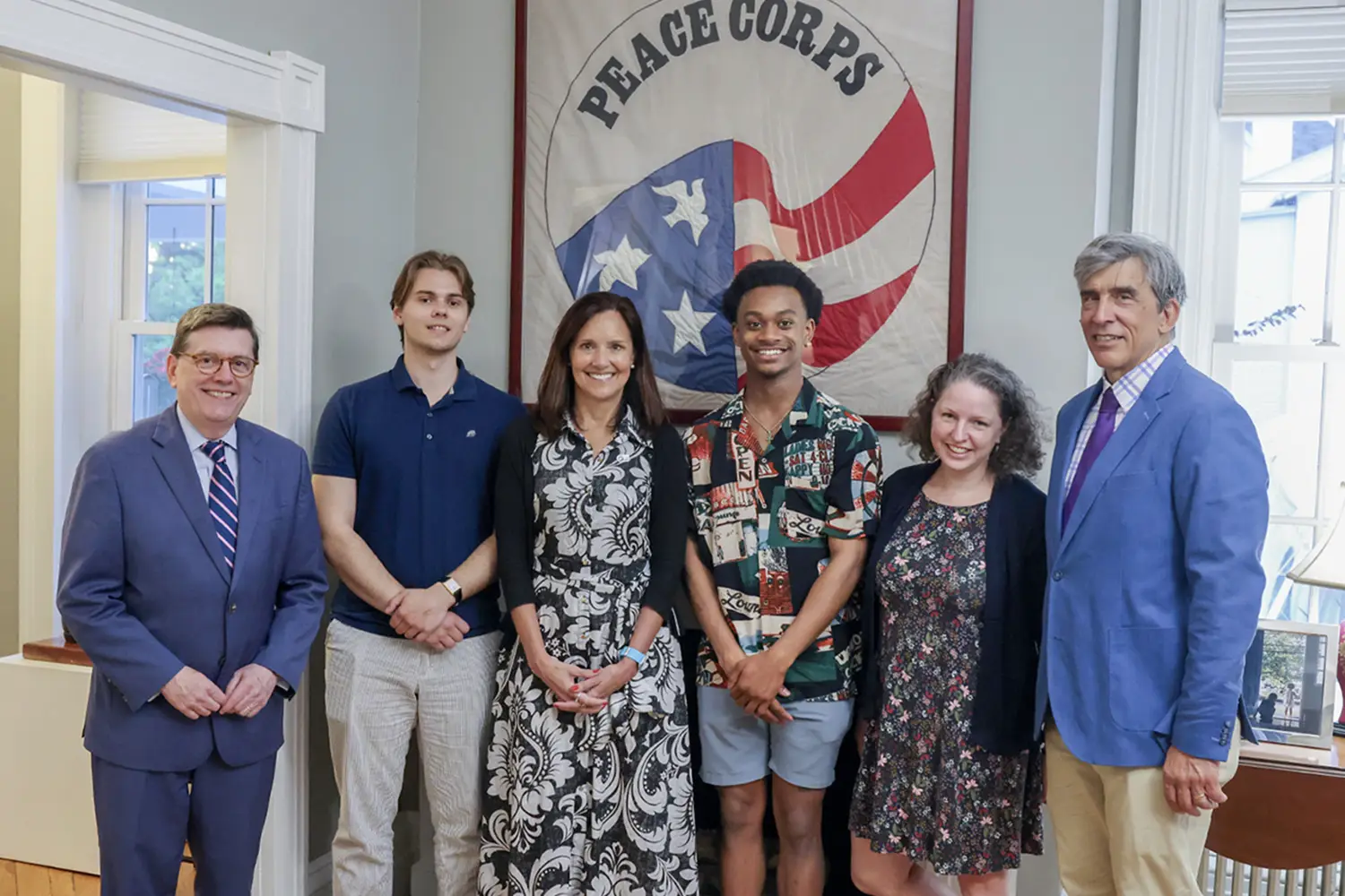 group photo in front of peace corps sign