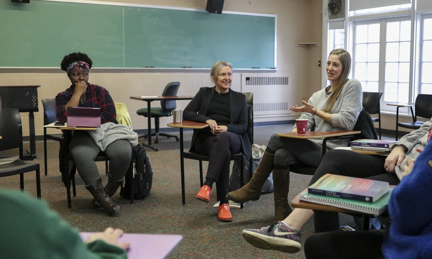 Betty Bayer in class listening to a guest