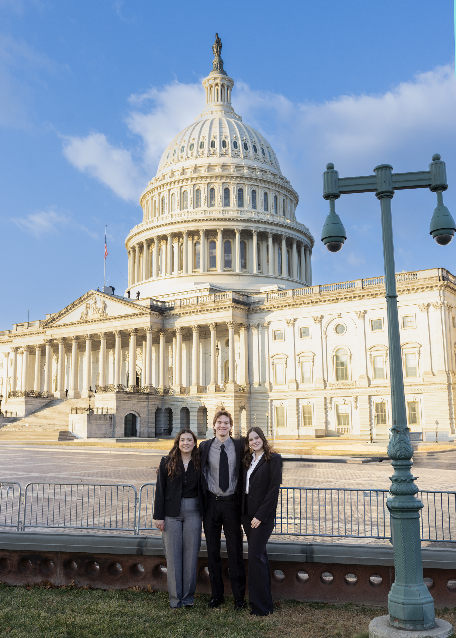 Bella Diamandis '28 and students pose for a photo in front of the Capitol Building.