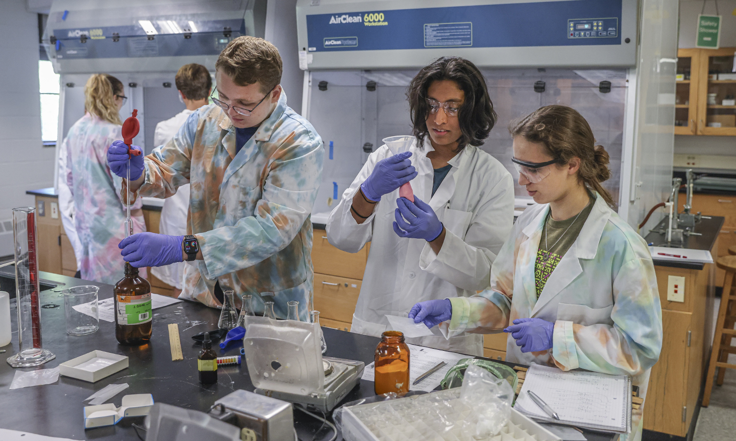 Thomas McCue ’26, Javier Pacheco ’26 and Rachel Faust ’26 work in the Accelerated General Chemistry lab of Technician David Slade on Thursday.