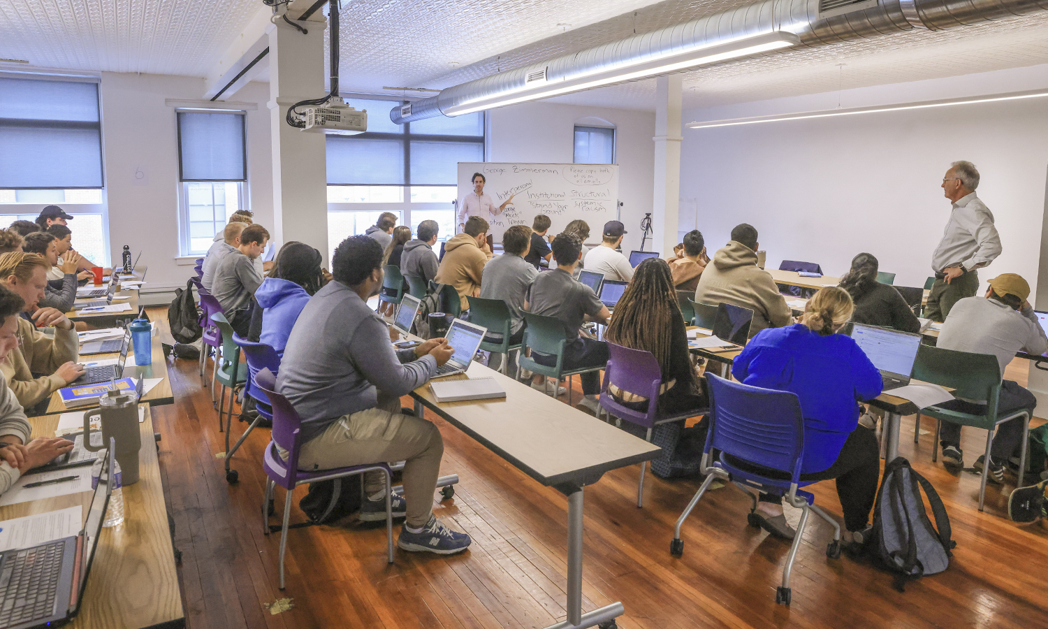  Visiting Assistant Professor of Environmental Studies Robinson Murphy and Professor of Economics Tom Drennen talk to graduate students during “Management Strategies for a Changing World.”  