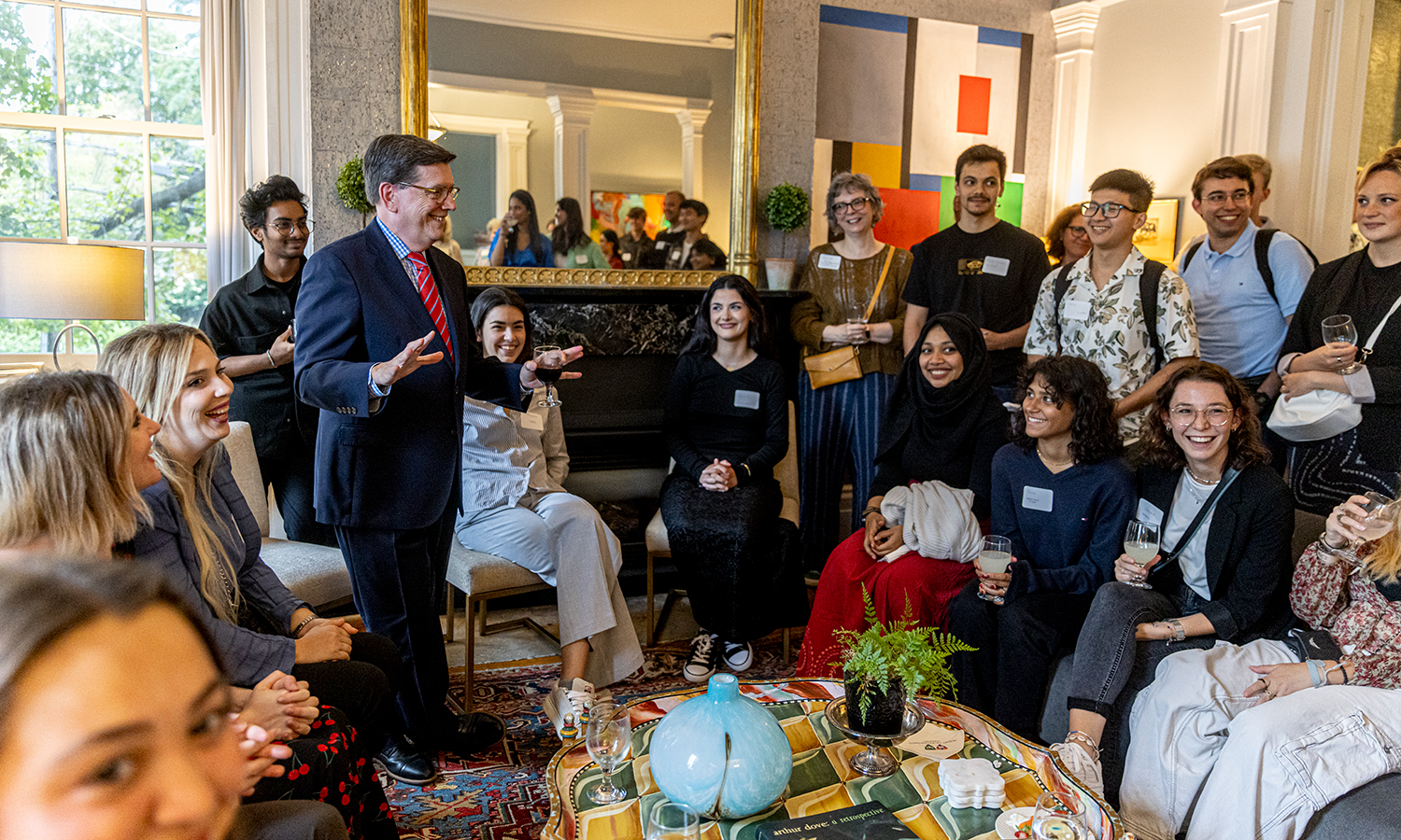 Students attend a dinner at the home of President Mark D. Gearan.