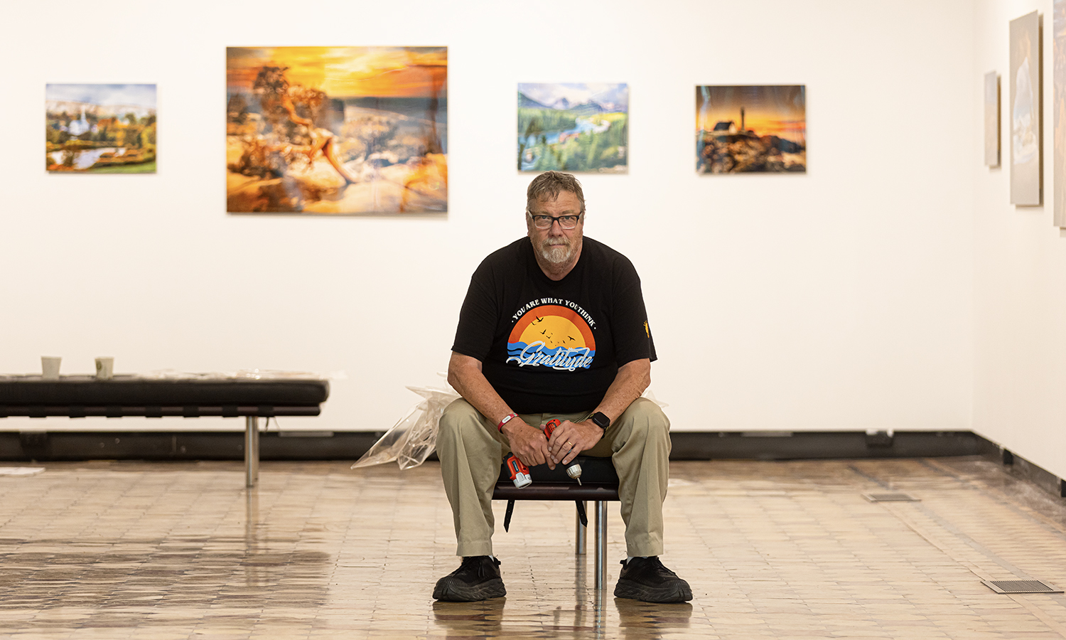 This week, we recognize the work of now retired Lead Photographer Kevin Colton L.H.D.’23. Here, Colton poses among a collection of his landscape prints at the Davis Art Gallery at Houghton House.