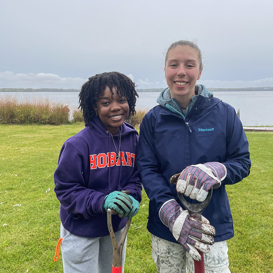 Bianca Jameau ‘24 and Karina Connolly ‘23 take a break while working at the Geneva Lakefront park as part of the fall Day of Service.