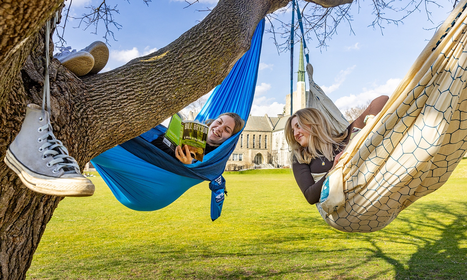 Annette Stephens ’24 and Hannah Mattey ’24 relax in hammocks on the Quad.