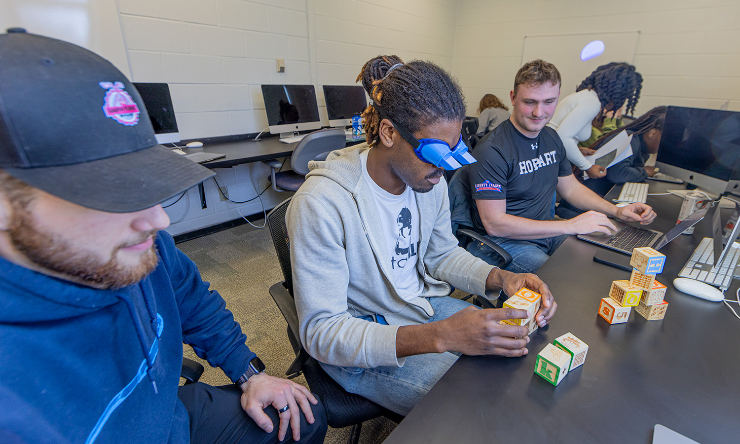 Students in Associate Professor of Psychological Science Daniel Graham’s “Capstone on Perception” perform a series of tasks using inversion goggles.
