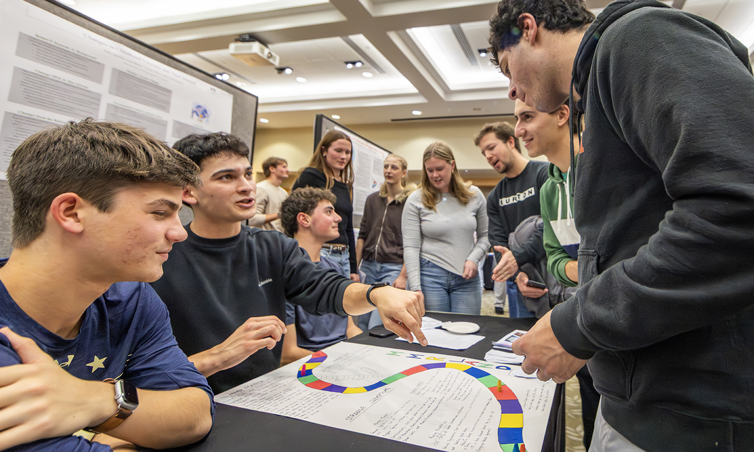 Students in “Game Changers: Disease, Cures & Social Change” with Professor of Biology Sigrid Carle ’84 present a board game they created during the class. 