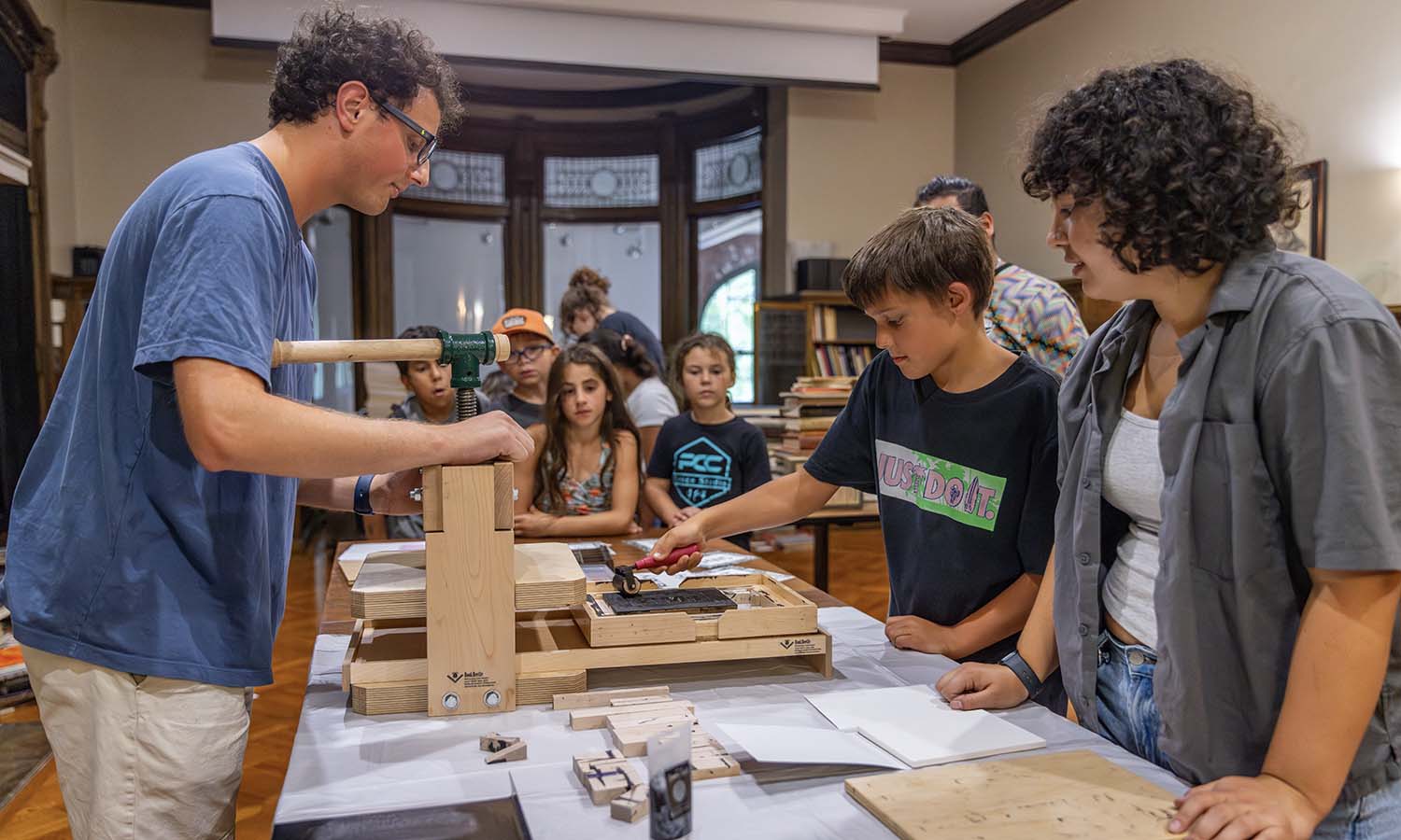 With direction from Professor of History Matthew Crow, Connor Gasper ‘26 and Alyssa Hanuscin ‘27 lead a “Matters of Memory” program funded by the Mellon Foundation for local children to learn about the printing press. 