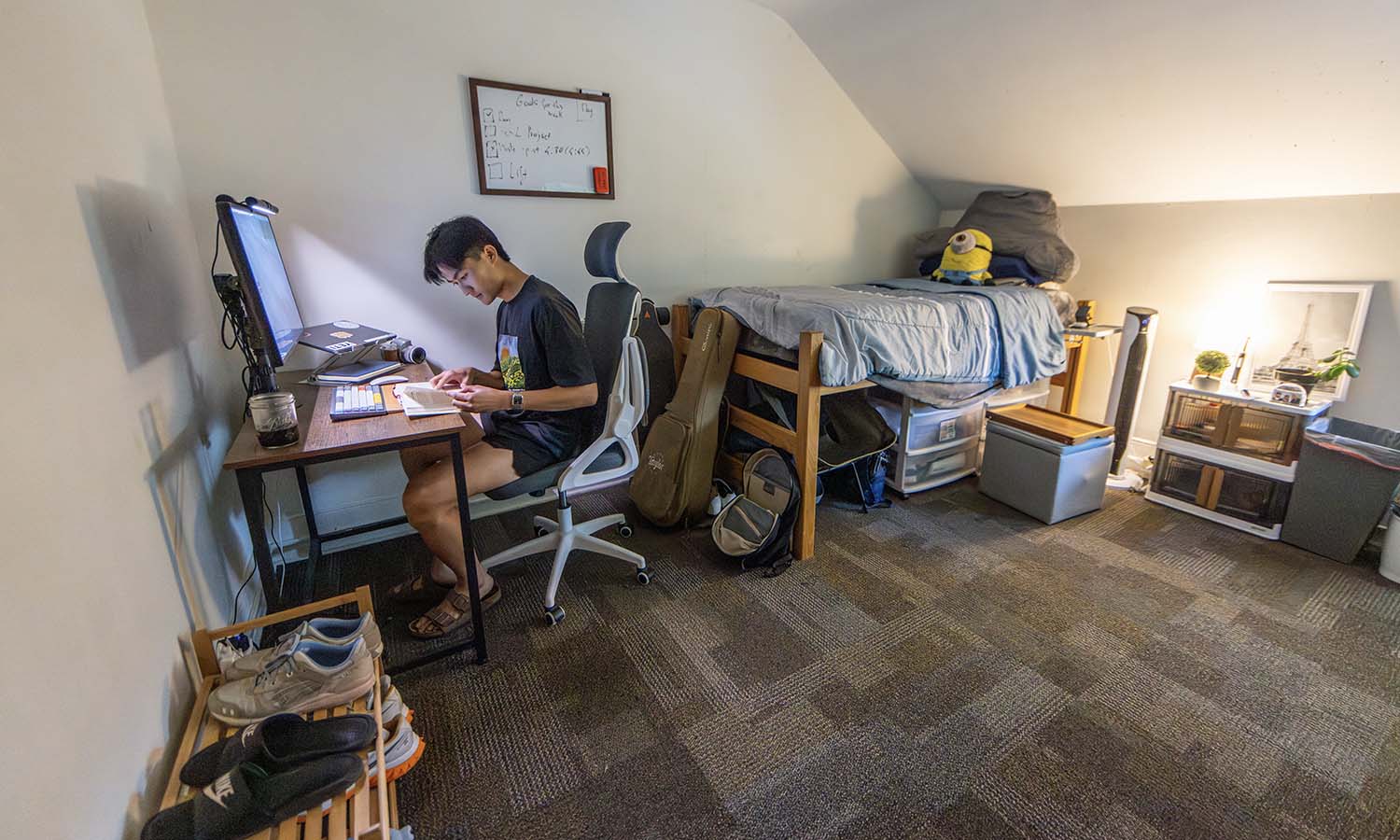 Andy Dinh ’27 works in his McCormick House dorm room, where he is living this summer. 