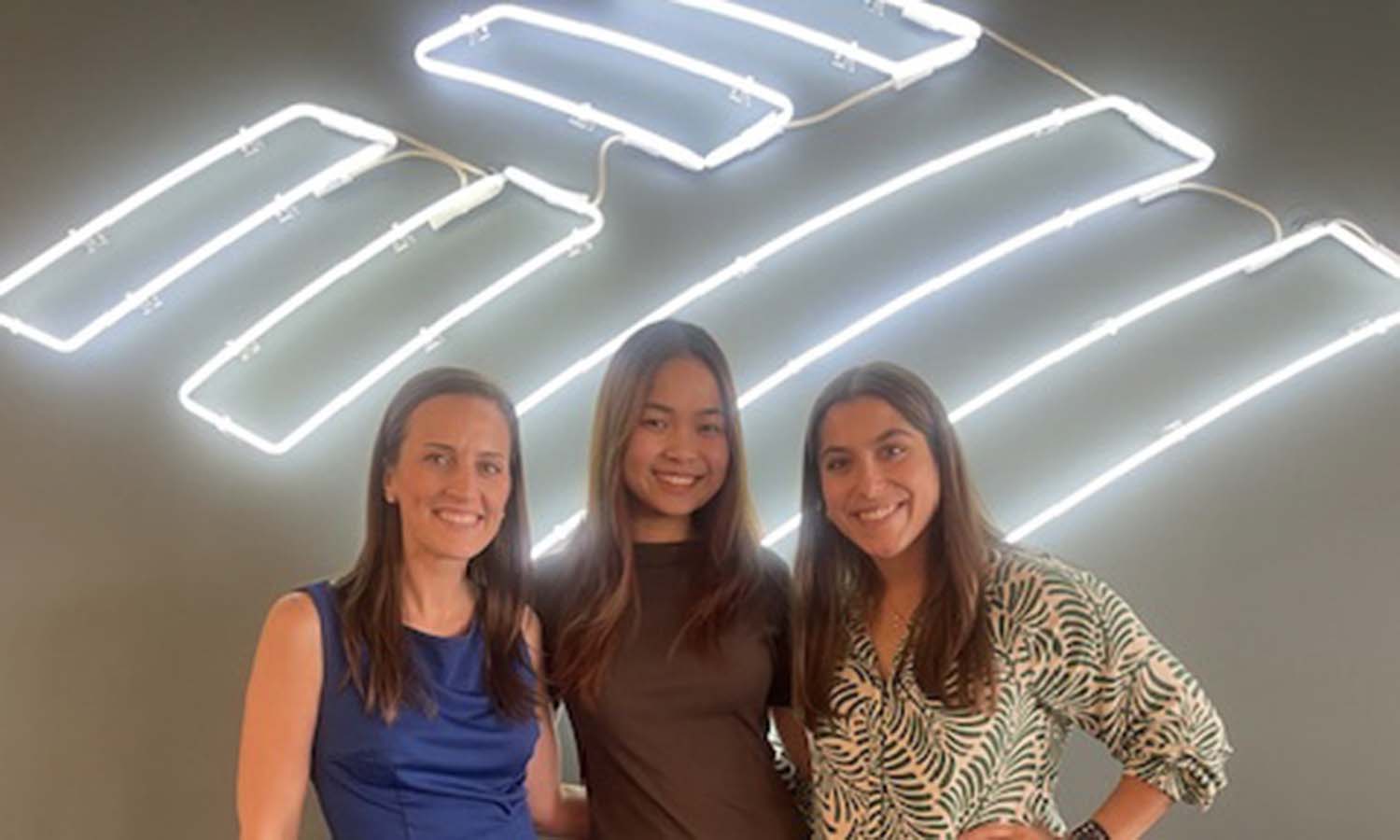 Director of CashPro Product Management Kiersten Hamilton ‘12, Esme Pham ‘26 and Treasury Sales Officer Christina Mitrow ‘22 pose for a photo at Bank of America, where Pham completed an internship this summer. 