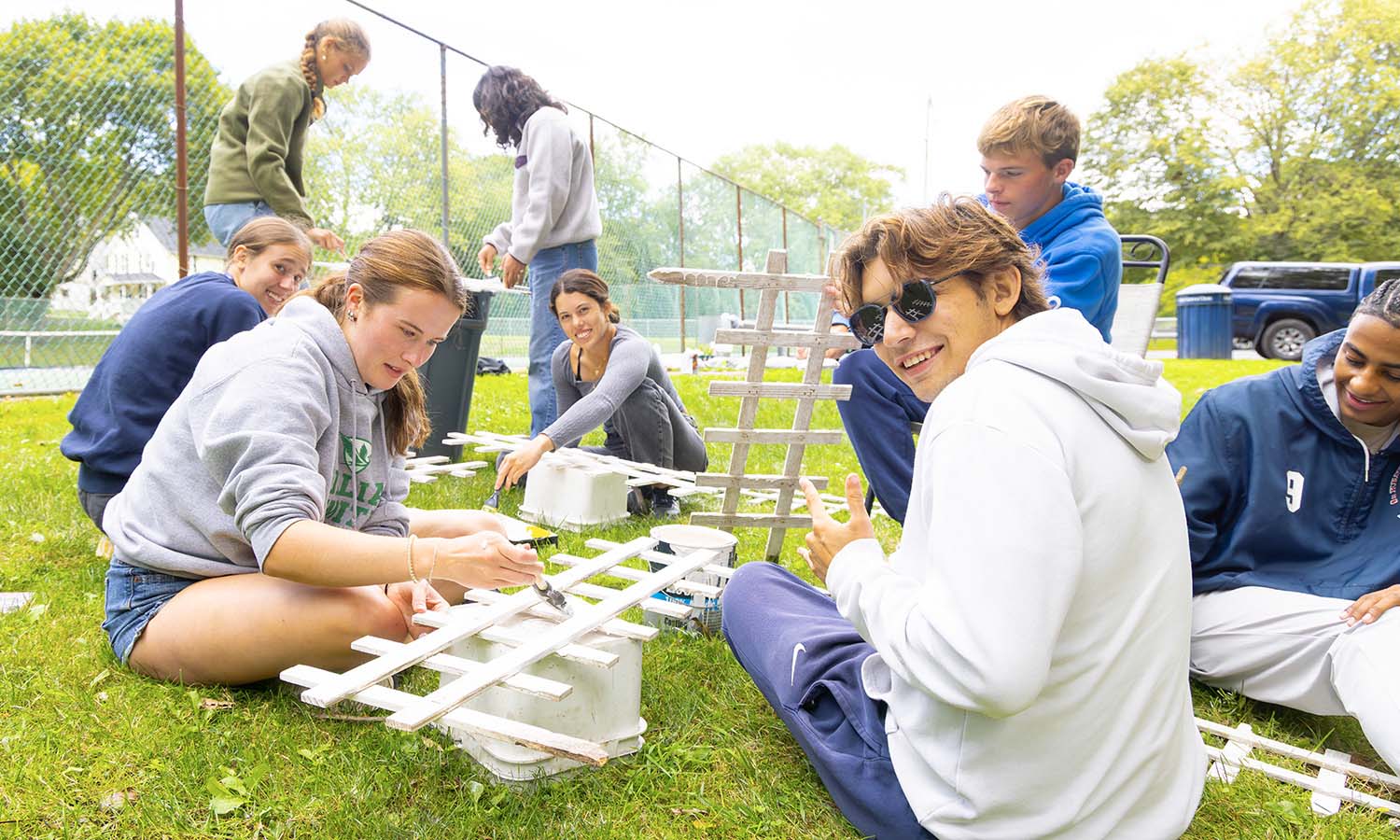 At Brook Street Park, students paint white picket fences. 