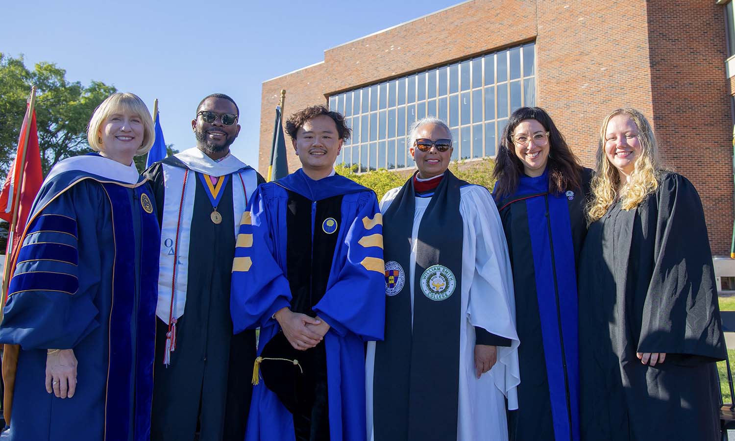 Associate Dean Amy Green, Assistant Dean Kelvin Clark, Assistant Professor of Media and Society Jiangtao Harry Gu ’13, Chaplain and Dean for Spiritual Engagement Nita Byrd, Senior Associate Dean Kelly Payne and Emily Gorczynski ’26 pose for a photo following Convocation. 
