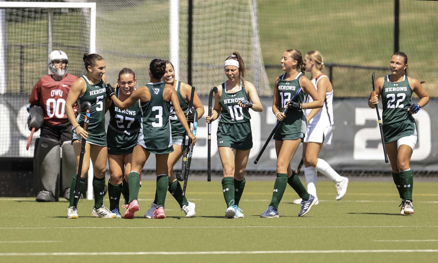 The William Smith field hockey team celebrates Madison Campisi's '28 first collegiate goal as the Herons defeated Ohio Wesleyan 3-0 on McCooey Field Sunday. 