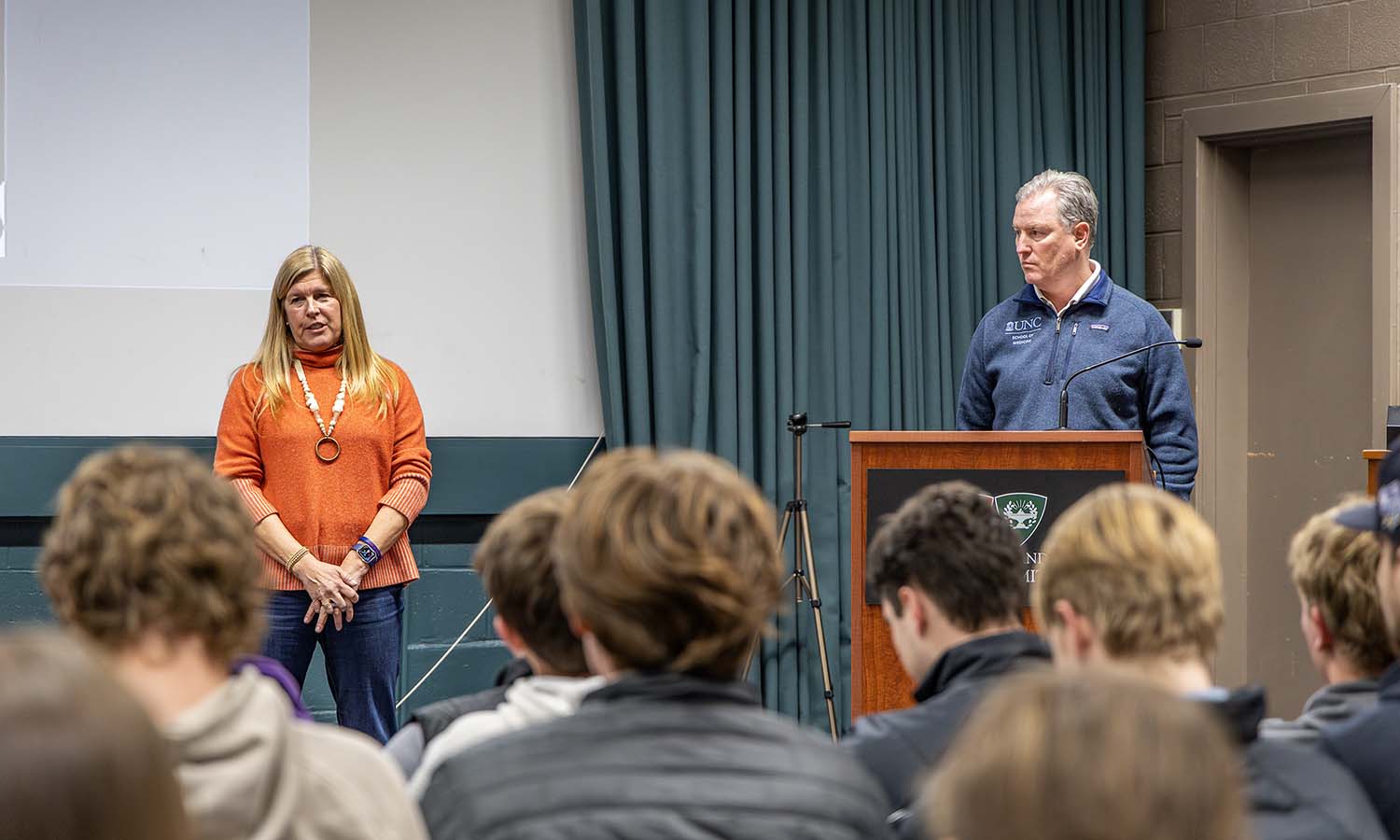 Heather Bonner ’88 and Sean Bonner ’88, founders of the non-profit Mission 34, gather with student-athletes following their discussion on mental illness. 