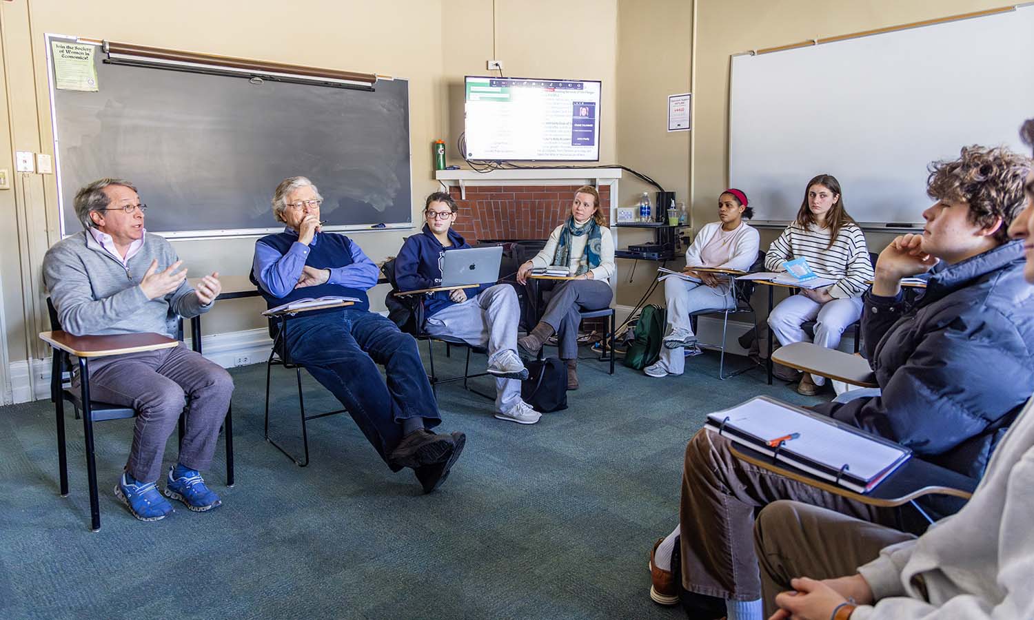 Former Trustee Michael Gantcher '92, P’27, joined by Professor Emeritus of Economics Patrick McGuire L.H.D.’12, talks to students in “Non-profit Organizations, Philanthropy and Impact” about the operation of the Gantcher Family Foundation. The course is taught by CCESL Director Katie Flowers and President Mark D. Gearan. 