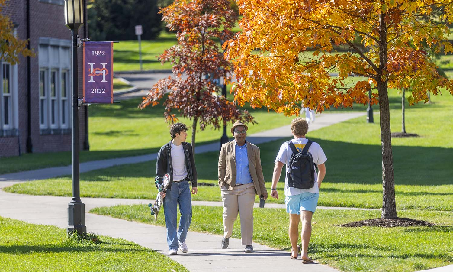 Hudson Chou ’27 and Associate Professor of Politics DeWayne Lucas chat while walking to class. 