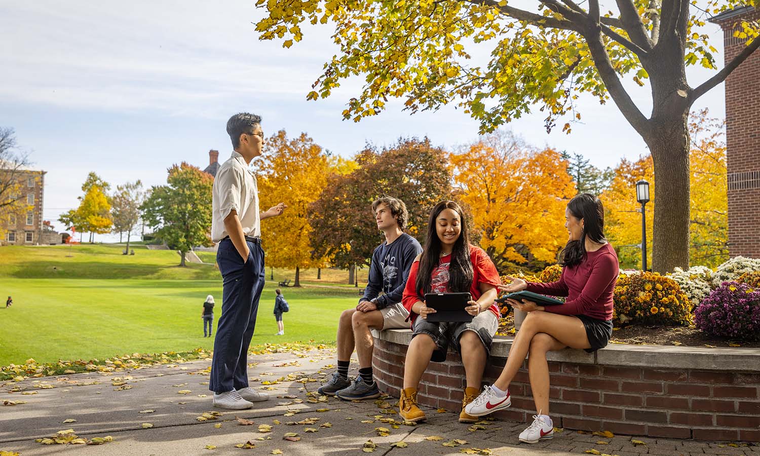 Randy Hong ’26, James Nelson ’26, Loreine Mungcal ’26 and Ariel Messenger ’26 prepare for a group presentation during “Anatomy” with Visiting Assistant Professor of Biology Thomas Jensen. 