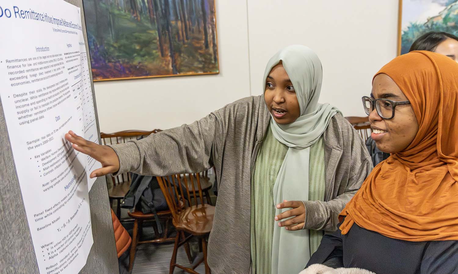Najma Ahmed ‘26 presents her research project during the “Econometrics” final poster presentations. 