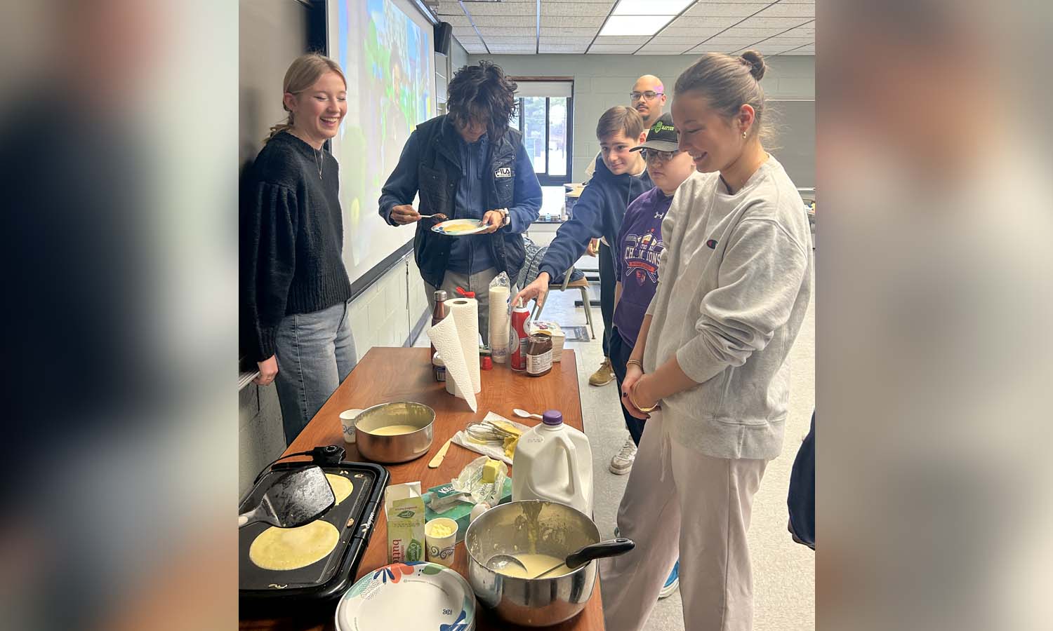 Students in “Beginning French I” with Adjunct Language Professor Shikha Mehta Demetro make crêpes on the last day of class. 