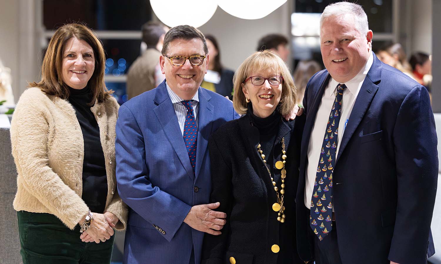 At the Boston Holiday Reception for alumni, parents and the HWS community, Maryann Shafter P'20, President Mark D. Gearan, Mary Herlihy Gearan and Andrew A. Shafter ’88 pose for a photo. The event was hosted by the Shafters at the John Hancock Headquarters. 