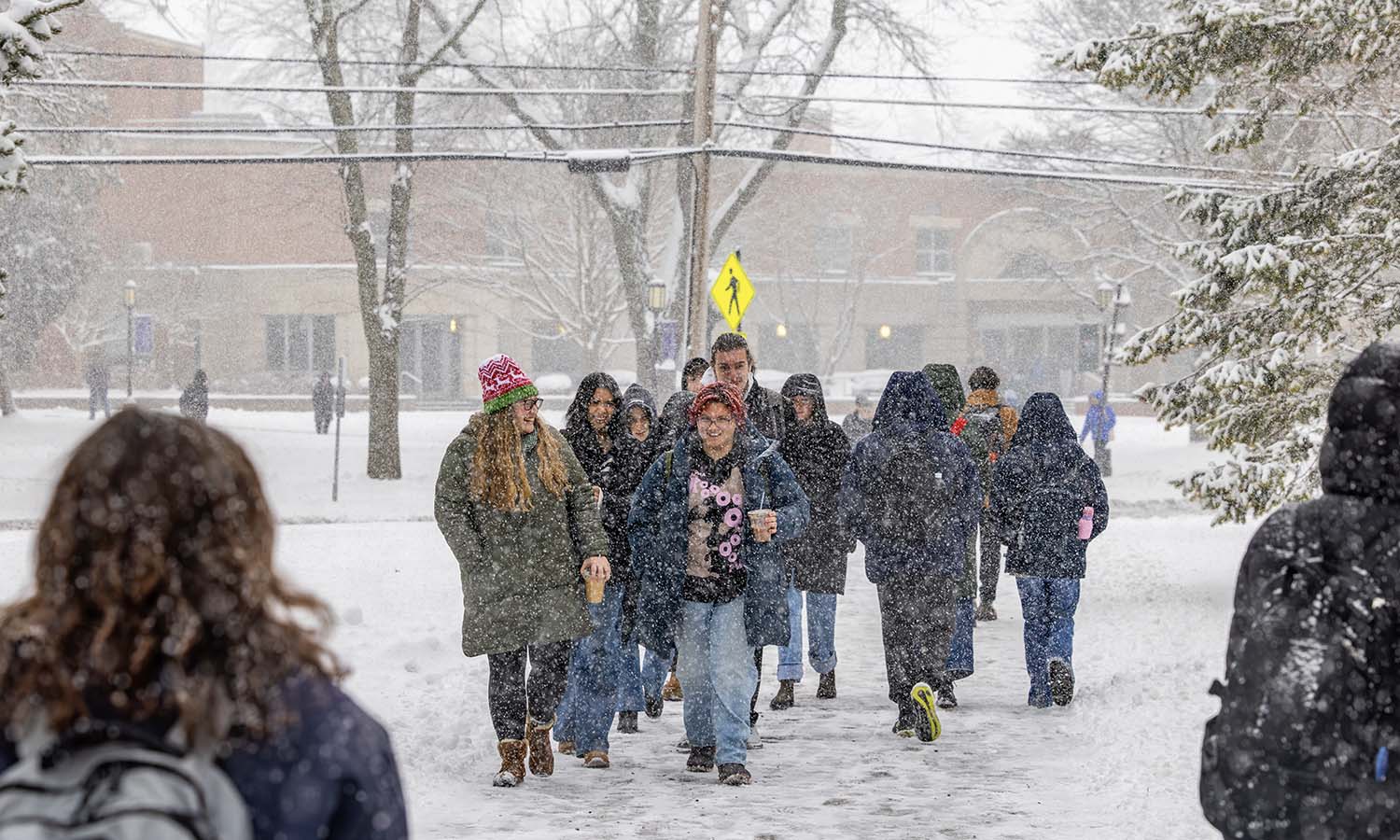 Students walk to class in the snow. 