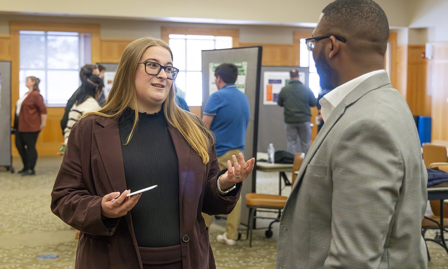 Hannah Green MHEL’26 discusses her research project with Assistant Dean Kelvin Clark as part of her course "History of Disability" with Associate Provost Susan Pliner. 