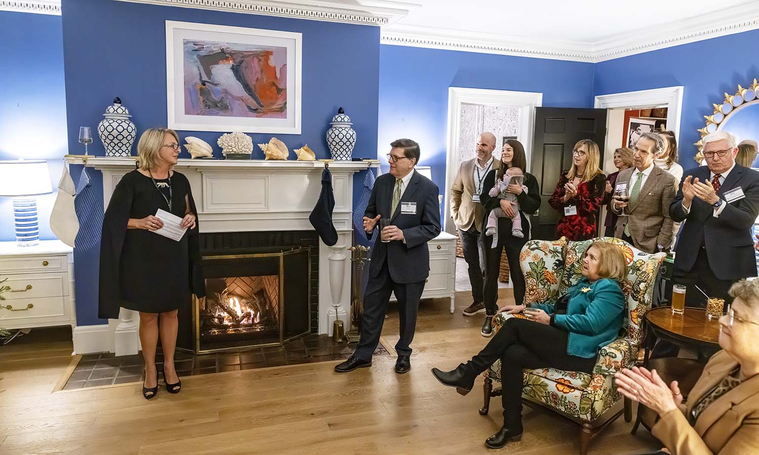 Chrissy Bennet West ’94 and President Mark D. Gearan speak to alumni, parents and friends at the Finger Lakes Holiday Reception. West hosted the reception at her home. 