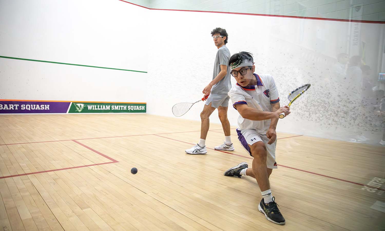 John Solano ’26 hits a backhand in Hobart squash’s home opener against Chatham. 