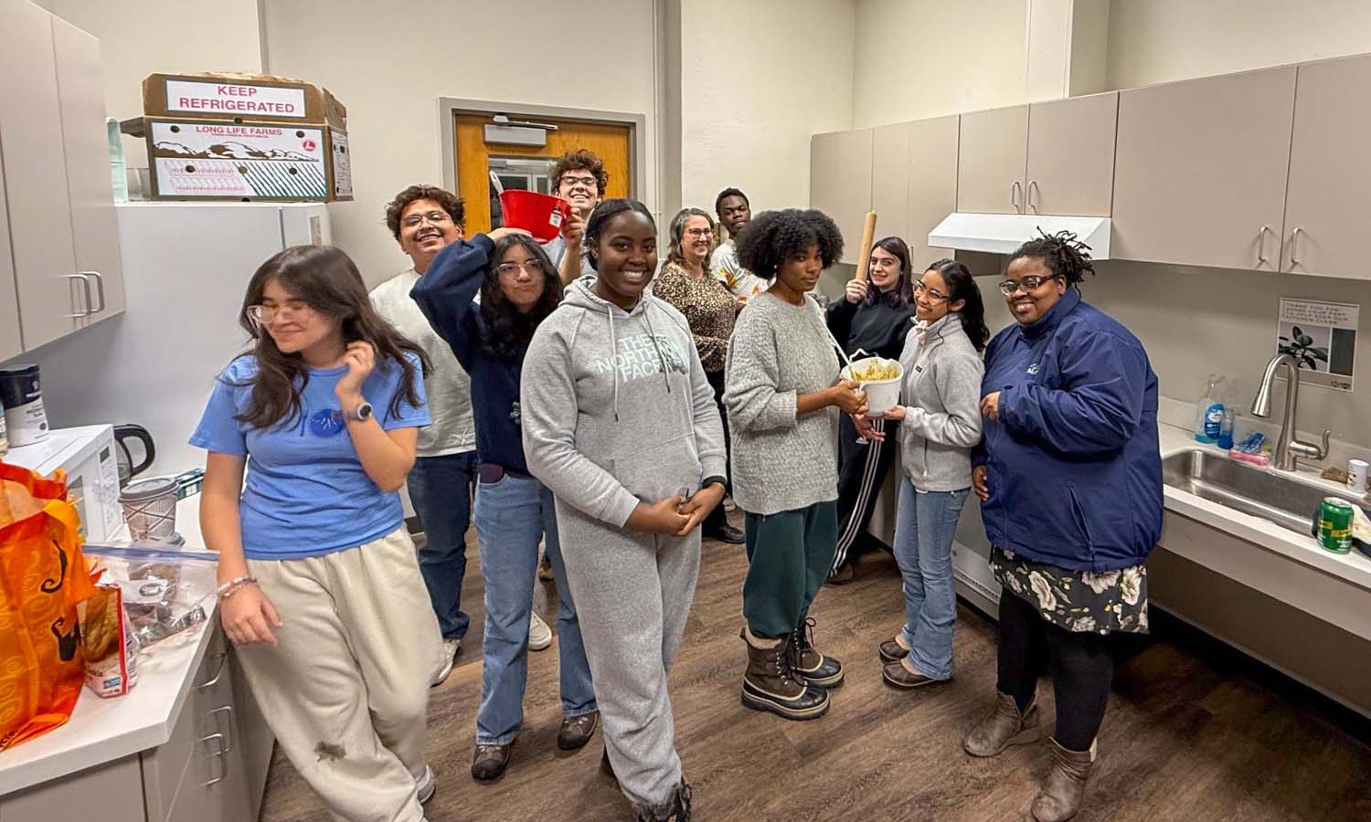 While baking cookies in the Hirshson Hall kitchen, members of Posse 13 pose for a photo with Associate Professor of Environmental Studies Whitney Mauer and Assistant Vice President of Diversity, Equity and Inclusion Renée Grant. 