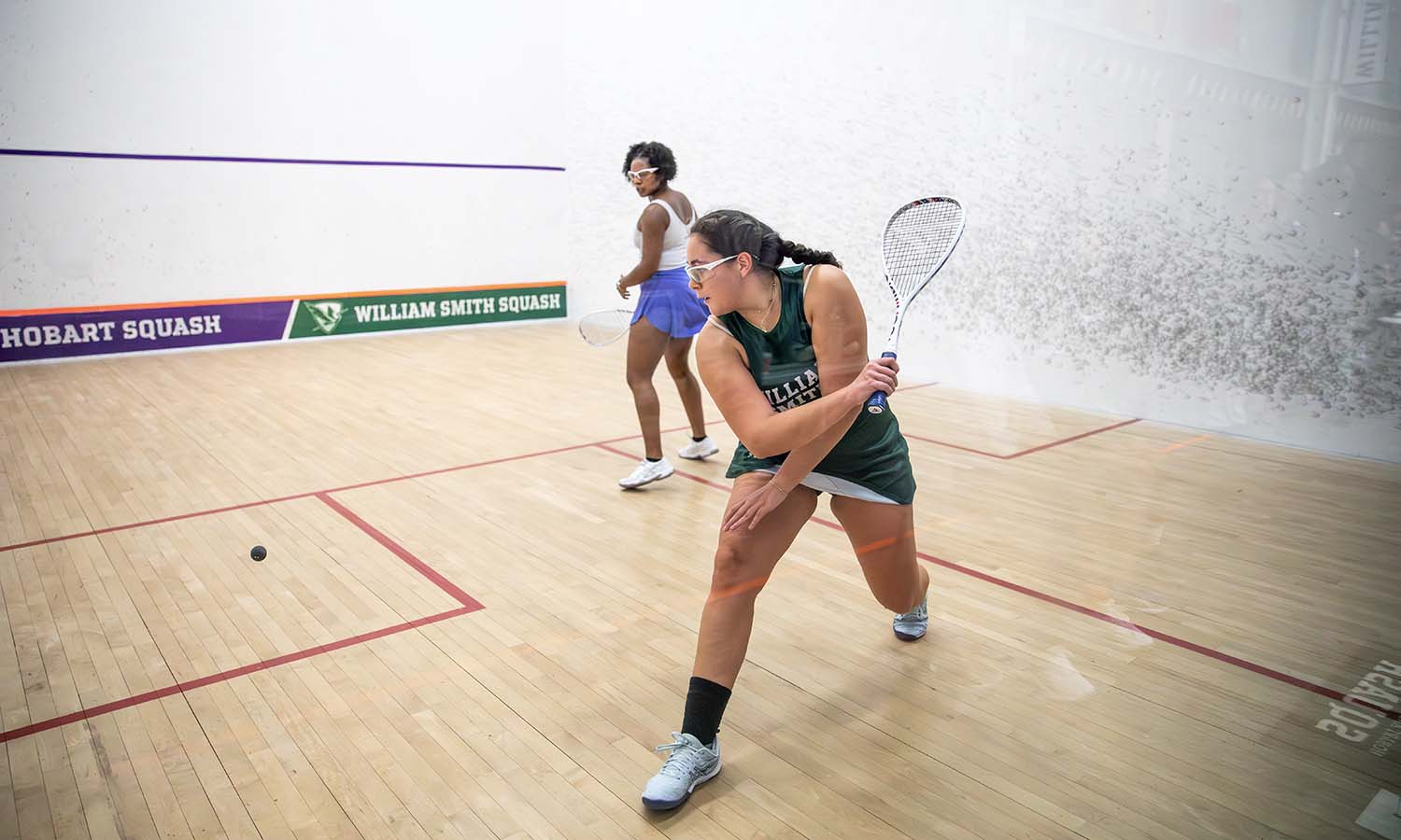 Scarlett Sandoval ’28 goes after a ball in William Smith squash’s match against Chatham. 