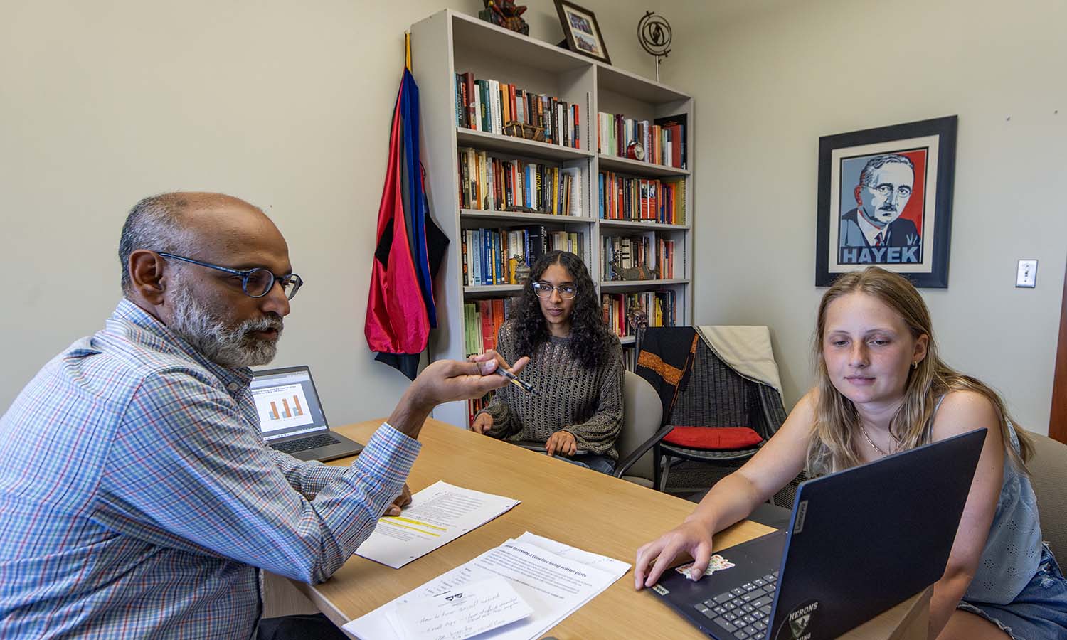 Professor of International Relations Vikash Yadav discusses data visualization techniques using Think-Cell software with Briana Reyes '27 and Emma Aluck '27. Reyes is studying the correlation between malnutrition and the labor force participation of women in Pakistan while Aluck is using data to better understand Venezuelan migration trends through the Darién Gap. 