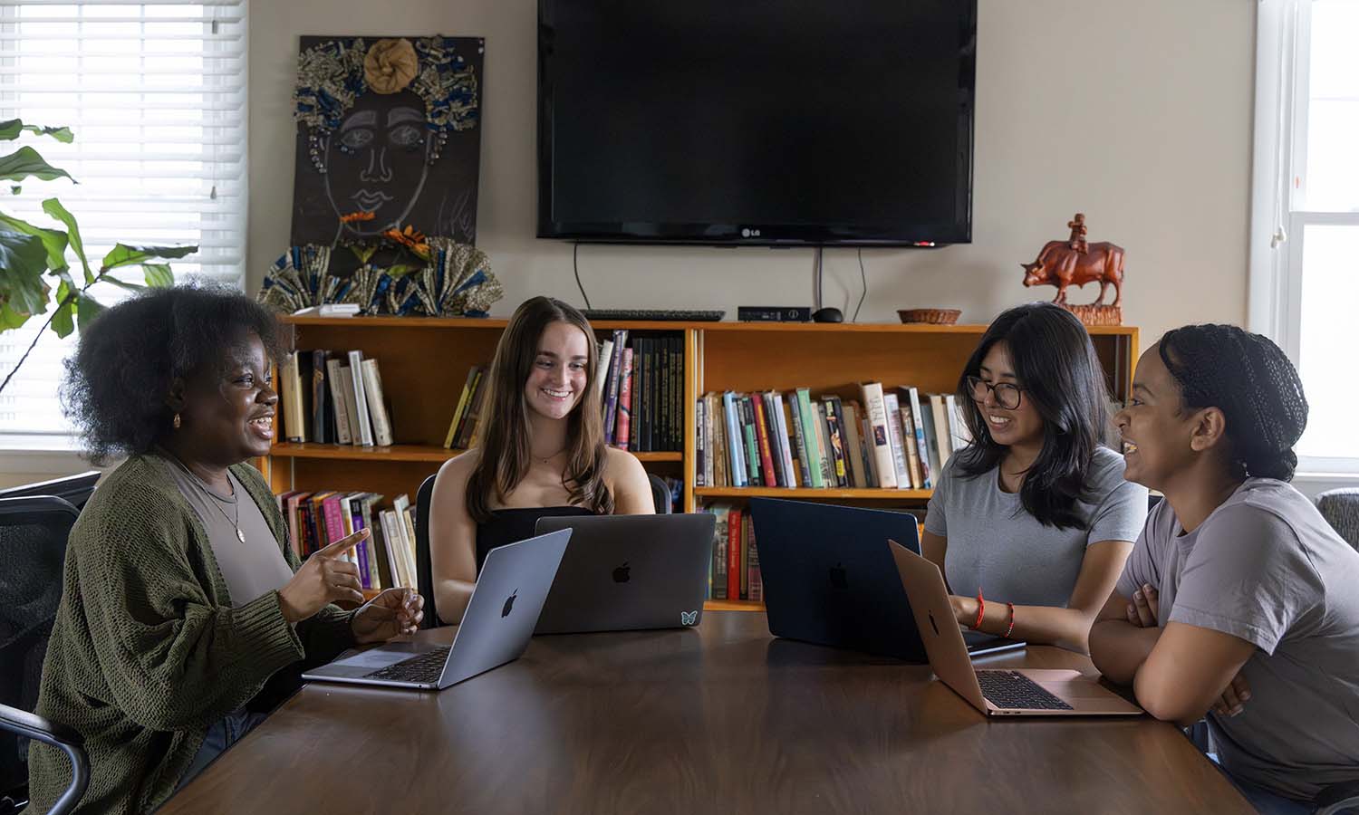 Olufisola Babalola ’27, Colleen Quirk ’27, Liliana Chavez ’27 and Lilay Abadi ’26 meet in the Adams Intercultural Center to work on a project exploring mental health in children and adolescents through the University of Rochester's Research/Project Experience program. 