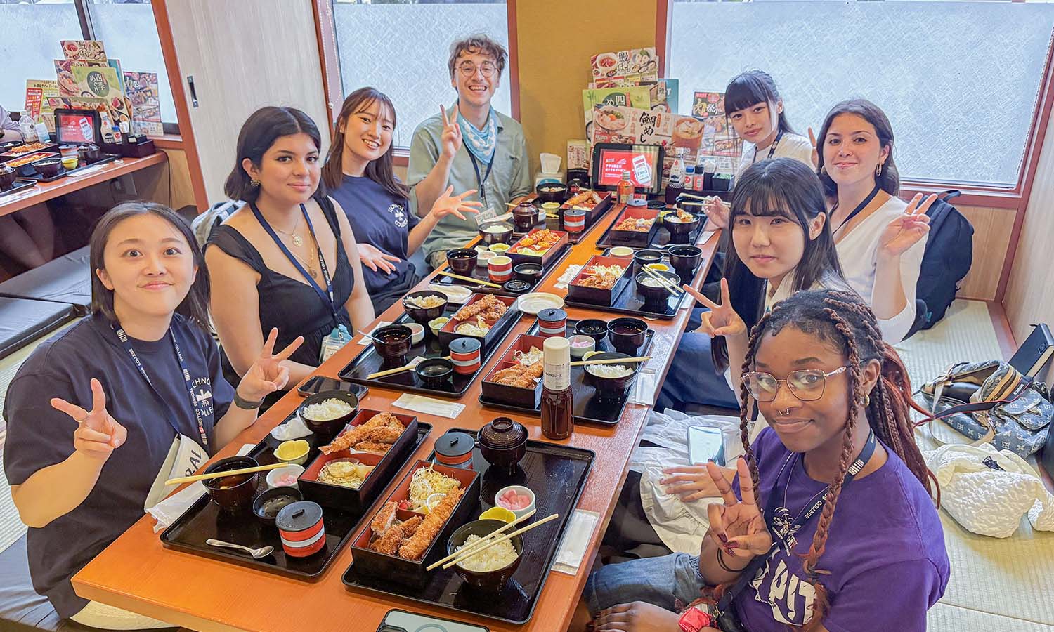 Juliza Ariza ‘27 (second from left) and Manuela Taff-Freire '27 (third from right) pose for a photo with fellow students in the intensive language and cultural exchange program at Technos International College in Tokyo, Japan. 