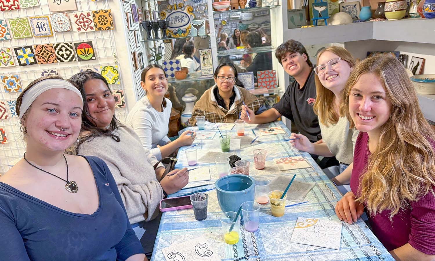 Ashley Hernandez '27, Sophia Pomposello '27, Nathan Deller ’27 and Ela Gardiner ’28 participate in a tile painting workshop in Seville, Spain.  