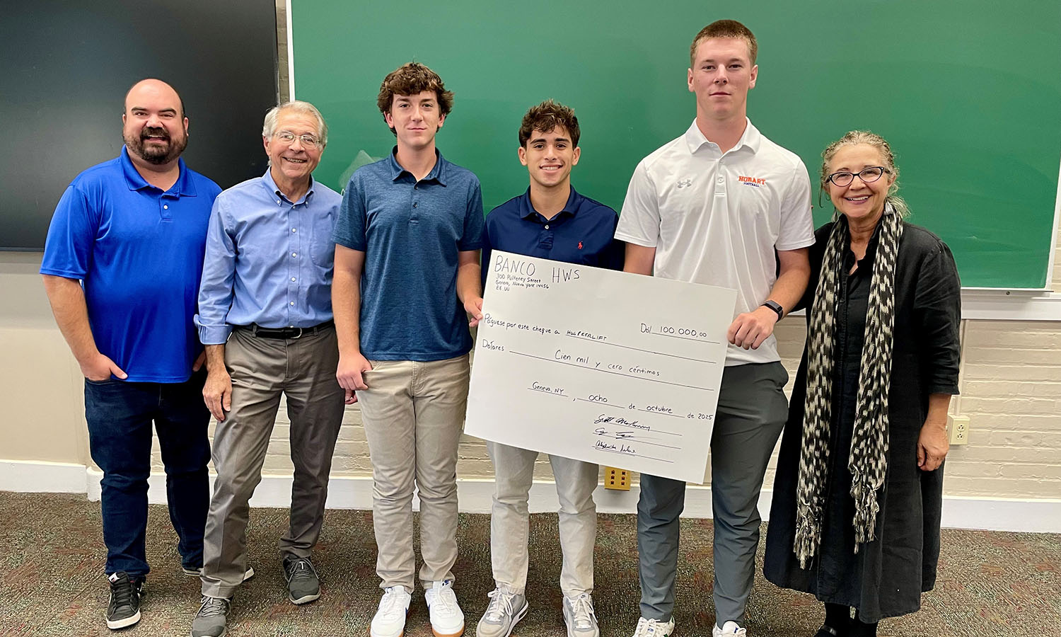 Professor of Spanish, Latin American, and Bilingual Studies Carolina Travalia’s “Spanish for the Professions” course holds its annual "The Pitch in Spanish” competition for bilingual entrepreneurs. Guest judges – including Associate Professor of Business Management and Entrepreneurship Craig Talmage, Emeritus Professor of Economics Scott Mckinney, and Instructor of Spanish, Latin American and Bilingual Studies Alejandra Molina – pose with the winning group of Tyler Snyder '29, Daniel Scali '29 and Collin Goff ’28. The team proposed HWS Peer-Lift, a ride-share program. 