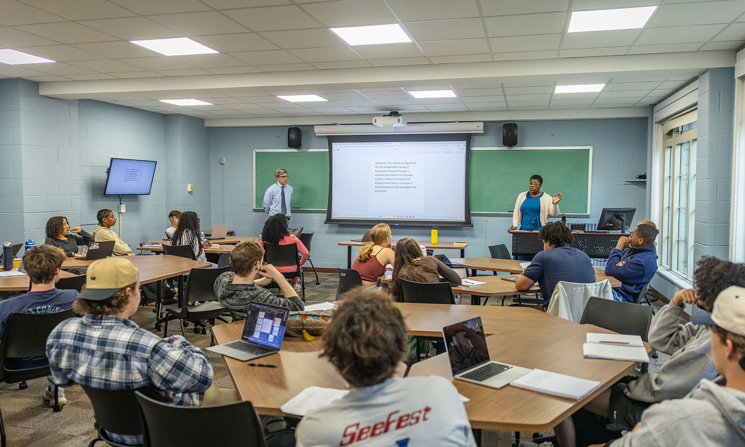 Professor of Religious Studies Richard Salter and Associate Professor of Economics Keoka Grayson review course material prior to an exam in "Racial Utopias." 