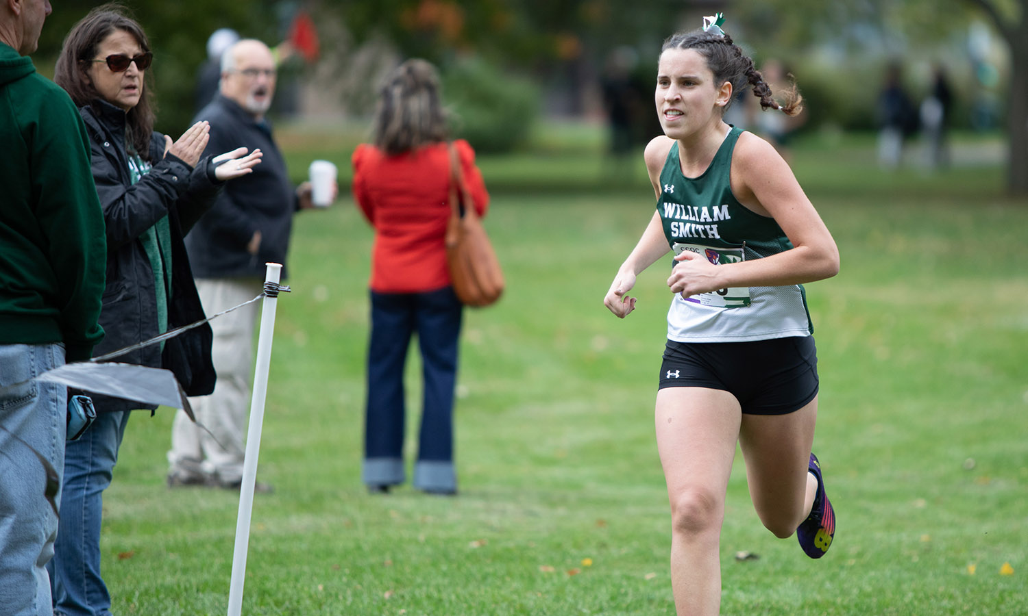 Hope Johnson ’26 sprints down the homestretch of the Cross Country Only Conference Championship. She won the CCOC individual title for the second year in a row and led the Herons to their fourth consecutive CCOC team championship. 