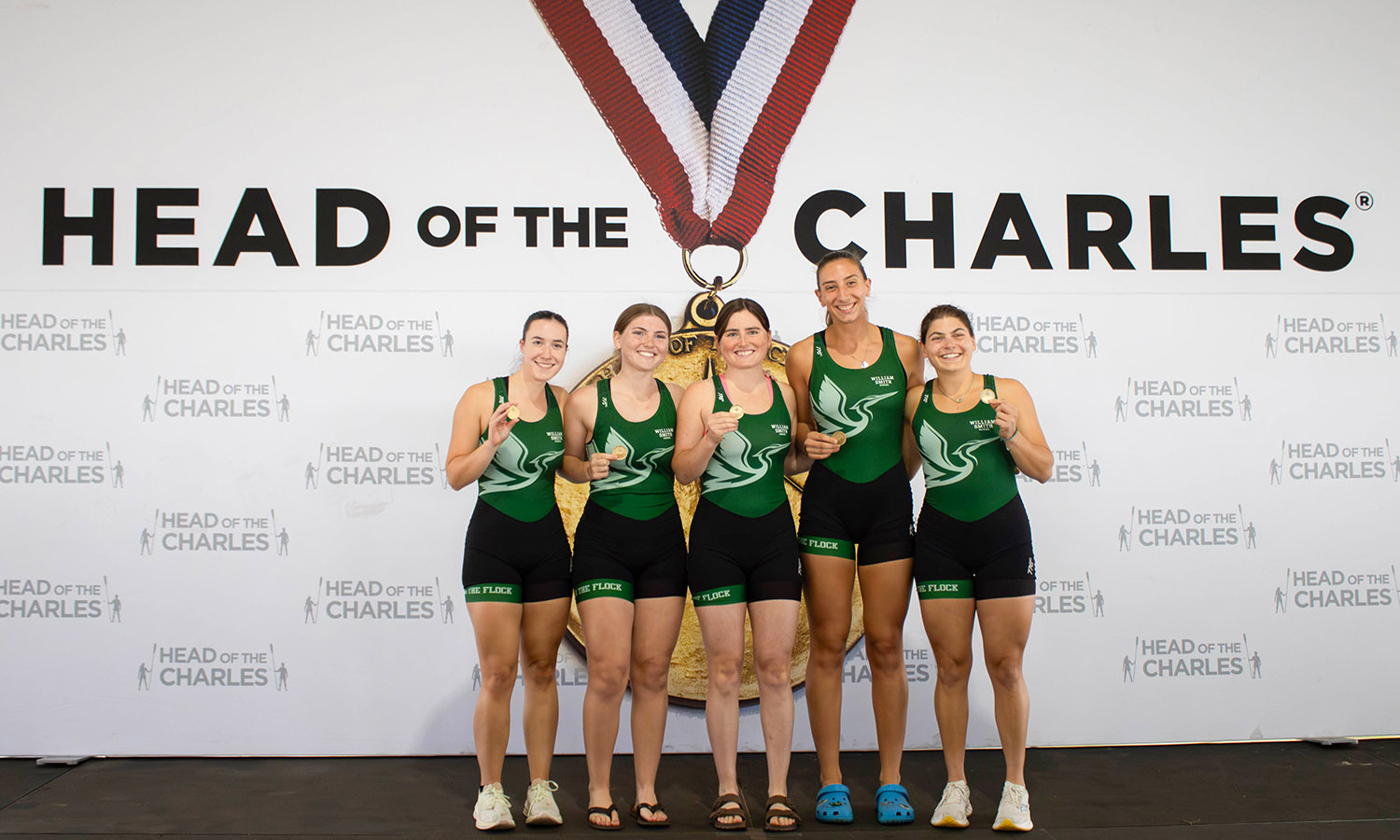 Meghan Bartholomay ’27, Aubrey Ryan ’26, Lizzy Whitney ’27, Kate Abdalla ’26 and Linea Darius ’26 pose with their silver medals at the Head of the Charles Regatta.  