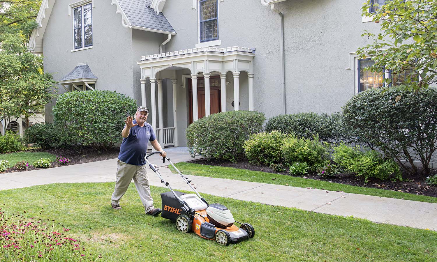 Buildings and Grounds’ Jeff Stahl mows the lawn outside of the Thomas Poole Family Admissions Center. 
