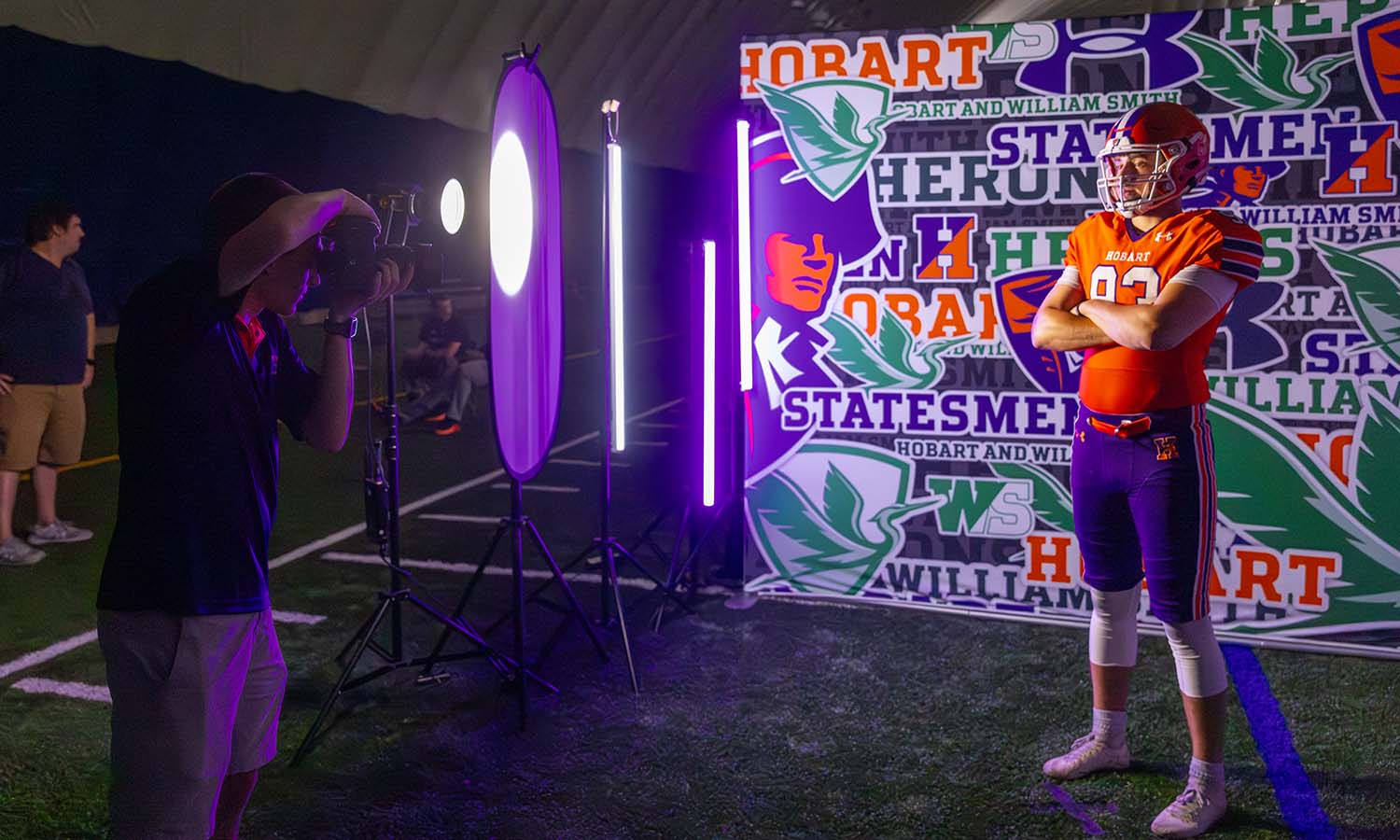 Photographer Adam Farid ’20 photographs Denzel Silver ’27 during Hobart football’s media day in the Poole Family Dome. 