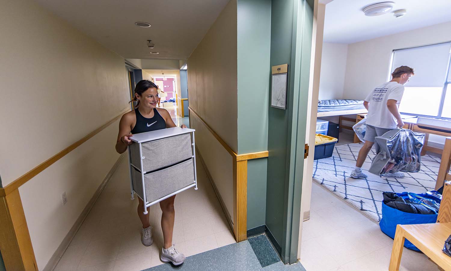 Heron soccer player Hannah Goodness ’28 moves into her residence hall in de Cordova Hall with the help of her brother. 