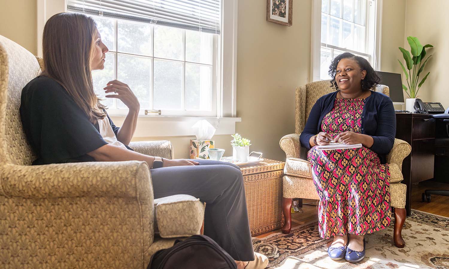 Staff Counselor Mary Martini-Hausner and Director of the Counseling Center Tasha Prosper converse at the HWS Counseling Center. 