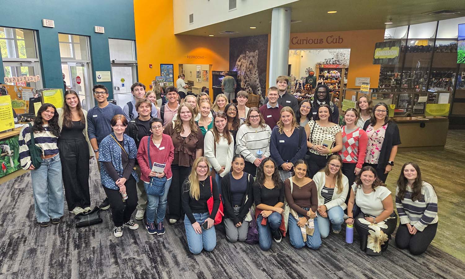 Students pose for a photo while attending the National Alliance on Mental Illness (NAMI) Syracuse Education Conference with Professor of Psychological Science Jamie Bodenlos. 