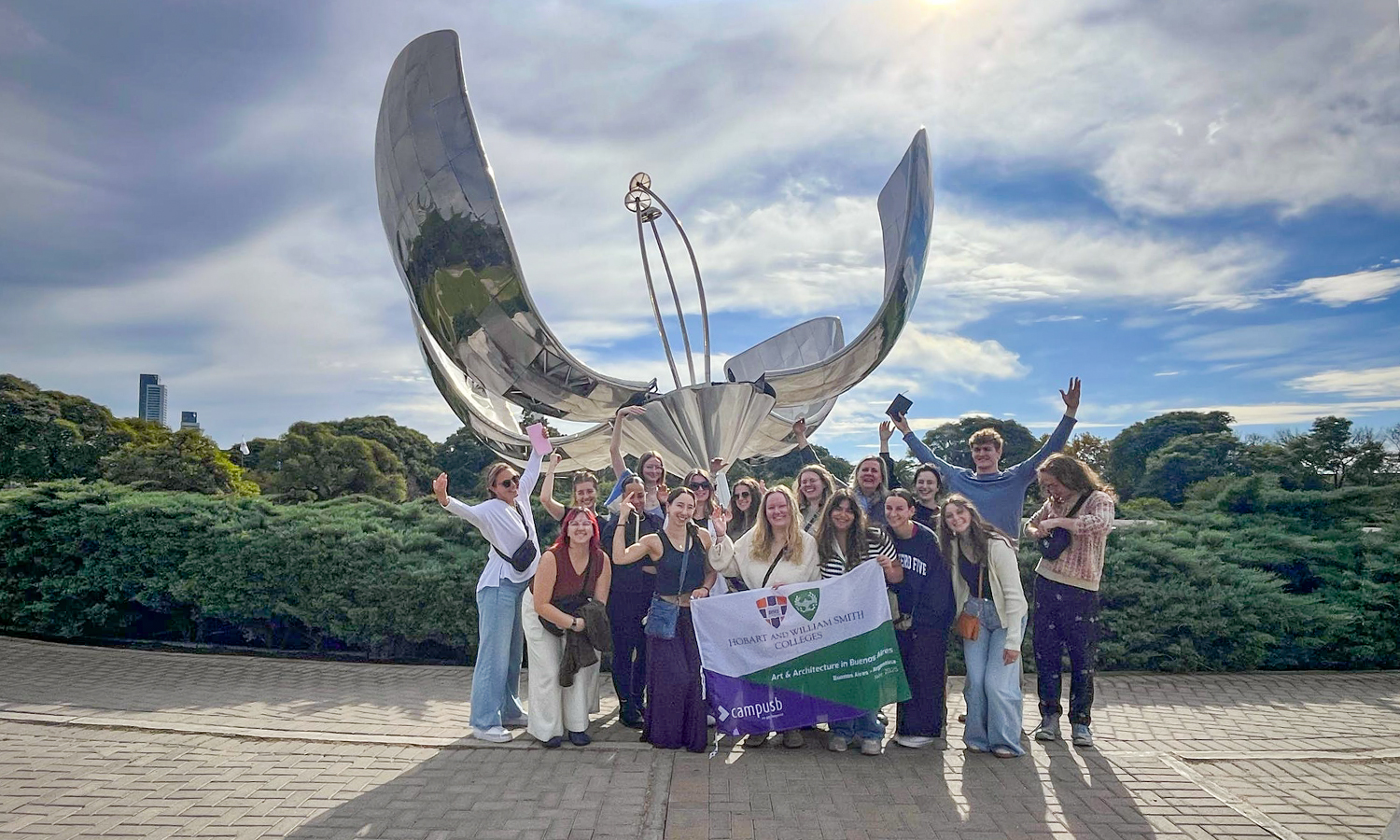 Students pose for a photo in front of Floralis Genérica, an 18-ton aluminium flower sculpture that was designed to open and close its petals with the sun, and a landmark of Buenos Aires, Argentina. 