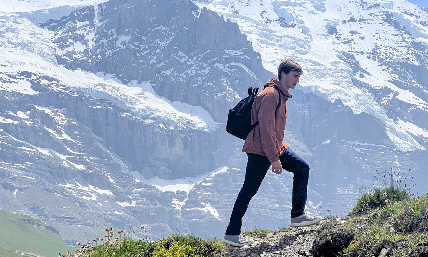 Parker Dudley '28 hikes with the mountain Jungfrau in the background. 