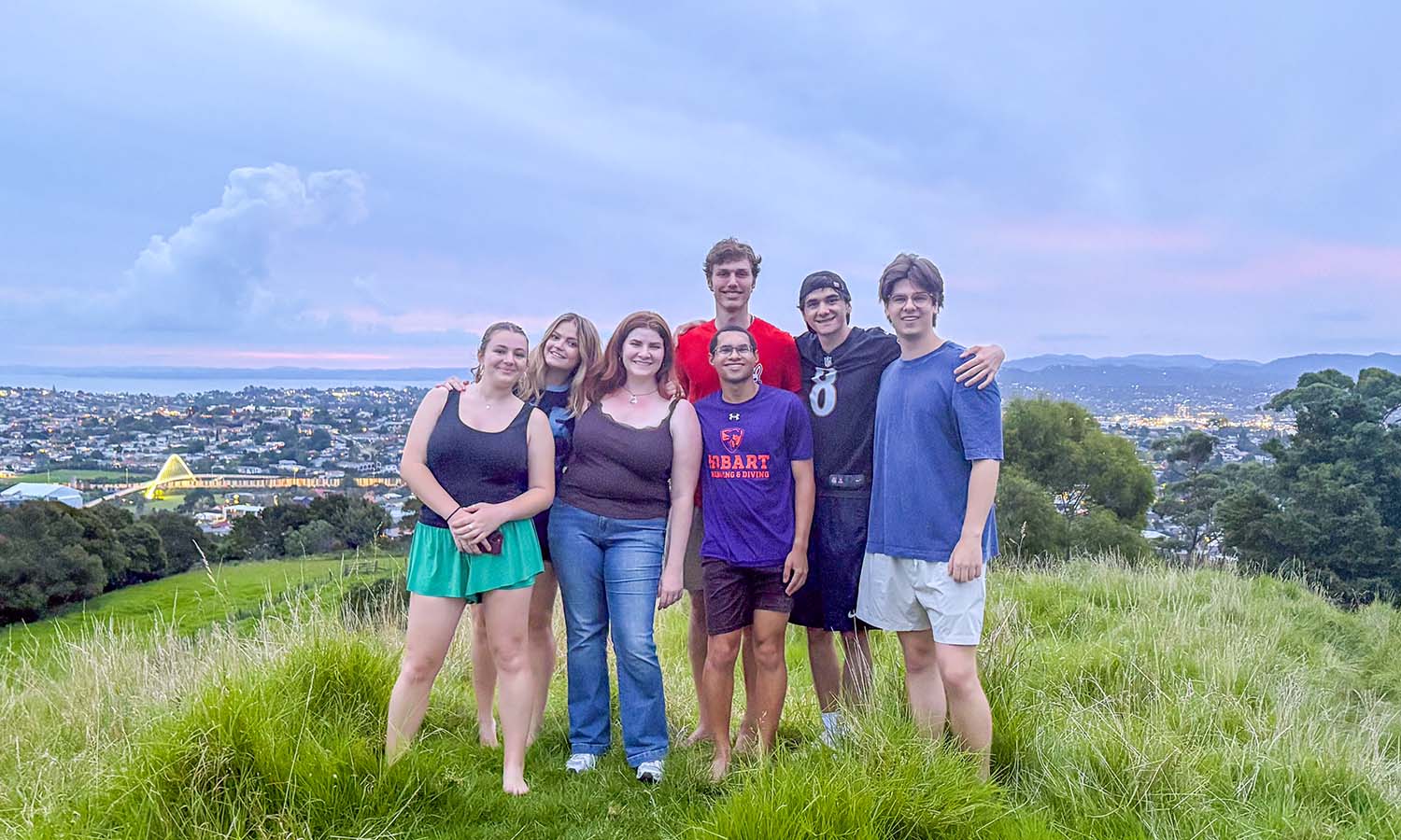 Students studying abroad in Auckland, New Zealand with Associate Professor of Economics Keoka Grayson pose for a photo at Mount Albert Park. 