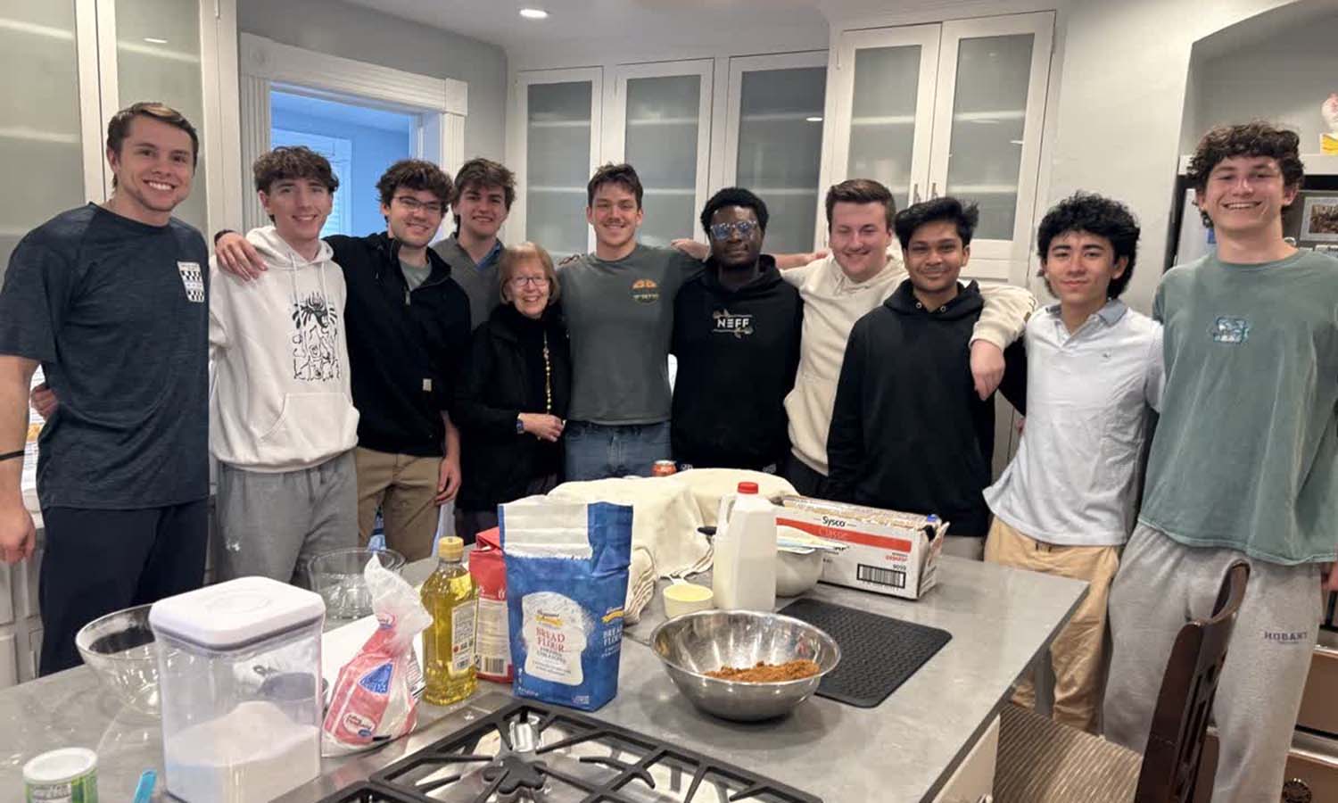 Mary Herlihy Gearan hosts Community Assistant Finn Palermo ‘28 and his Sherrill Hall residents and friends to bake cinnamon buns in the President’s House on Sunday afternoon. 